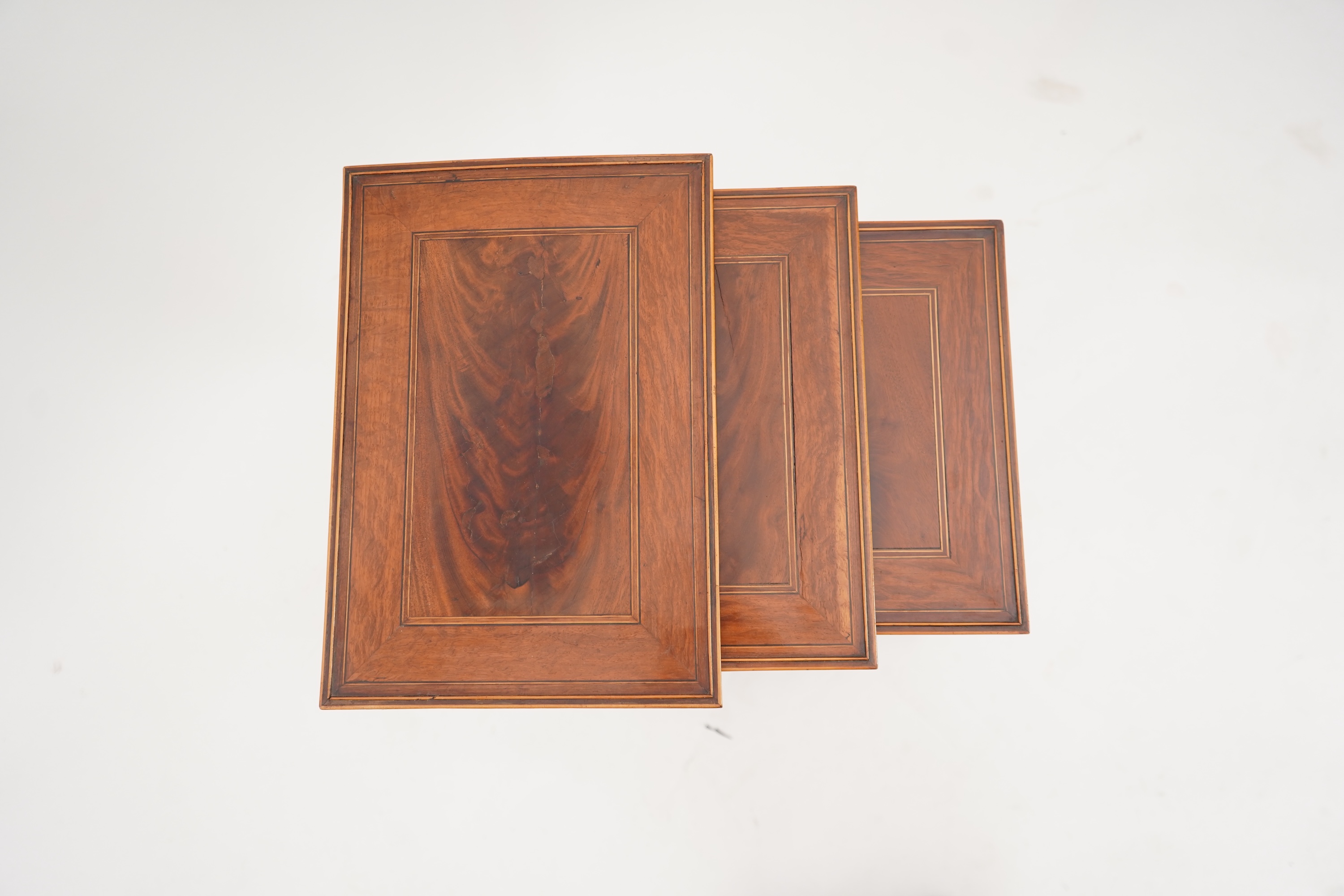 A nest of three George lll mahogany occasional tables